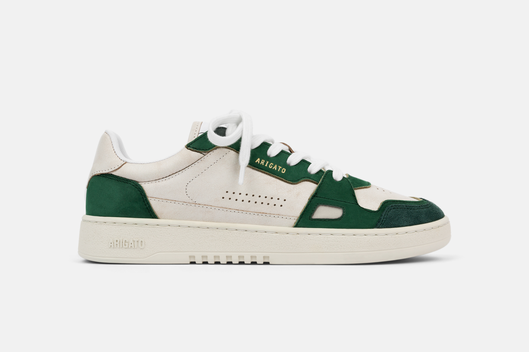 A single Axel Arigato Dice Lo sneaker in a white and green colourway