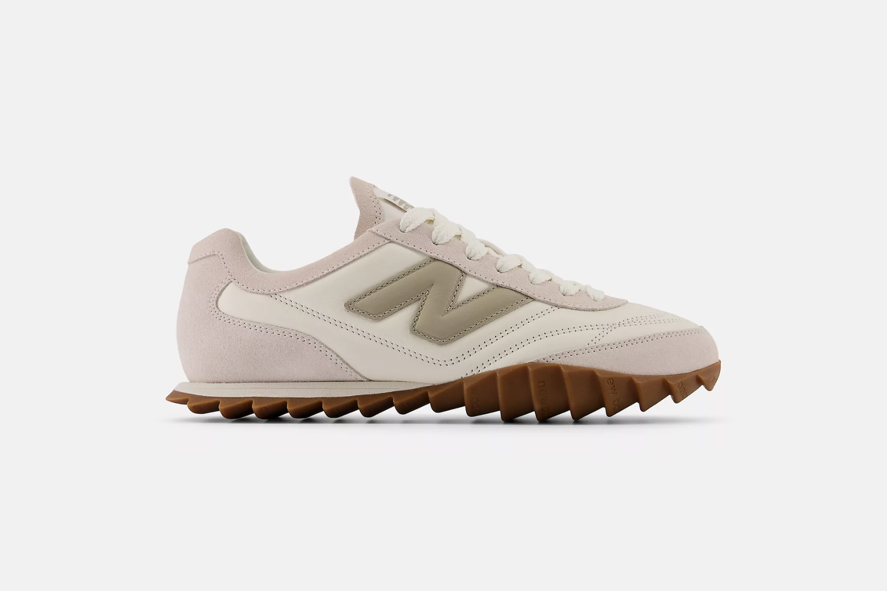 A single New Balance RC30 in an off white colourway with green detail